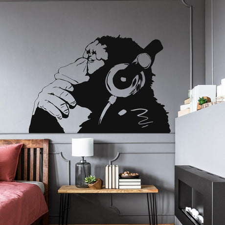 Thinking monkey wall sticker with headphones in a modern bedroom.
