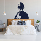 Street art policeman middle-finger wall decal displayed in a stylish bedroom.