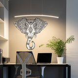 Tribal vinyl elephant wall sticker in a home office setting with modern decor and plant.
