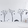 Stylish wall decal featuring black trees, birds, and a fox.