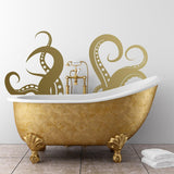 Gold octopus tentacles vinyl wall art sticker above a vintage bathtub, adding ocean decor to a bathroom.
