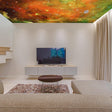 Colorful space theme ceiling vinyl sticker depicting galaxies and stars in a modern living room decor.