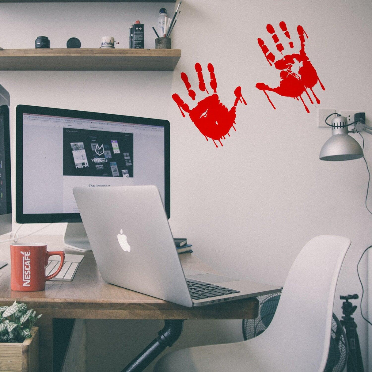 Bloody hands scary red vinyl sticker on a desk.
