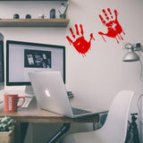 Bloody hands scary red vinyl sticker on a desk.