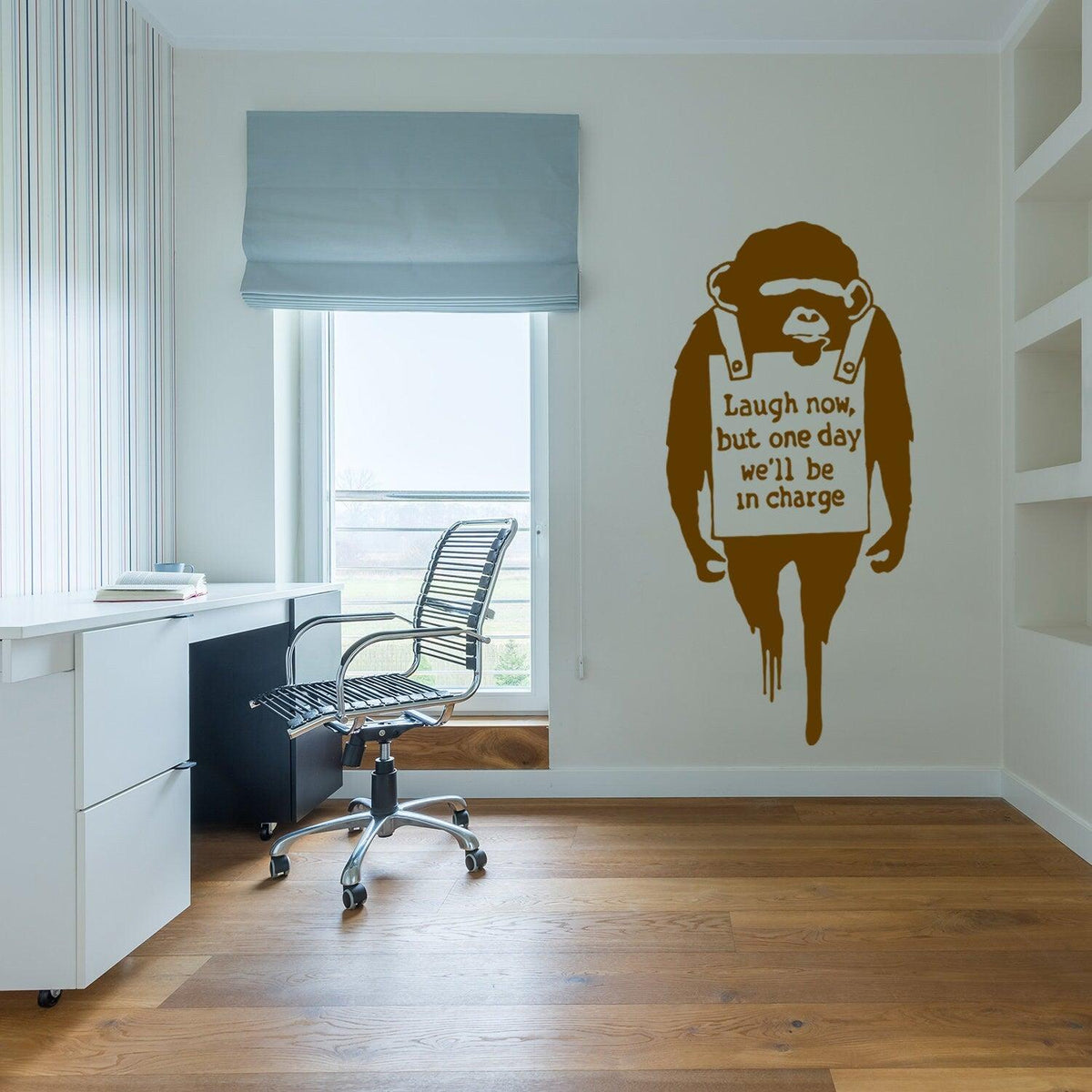 Laugh Now monkey wall sticker displayed in a modern office.