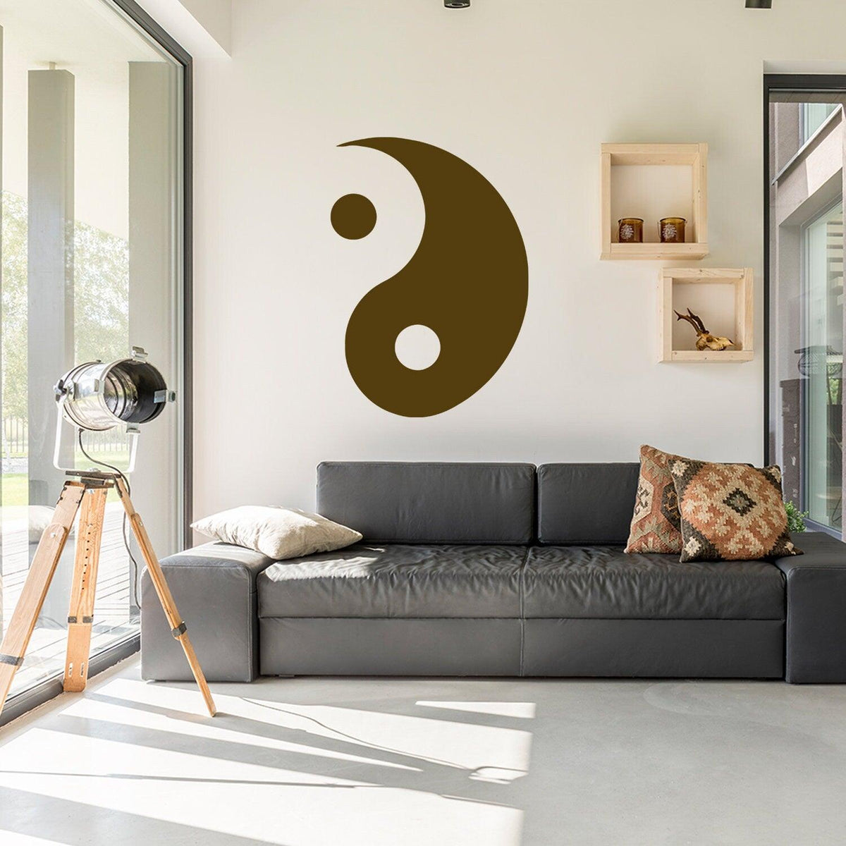 Yang Yin wall sticker vinyl decal on a living room wall above a black couch with decorative pillows.