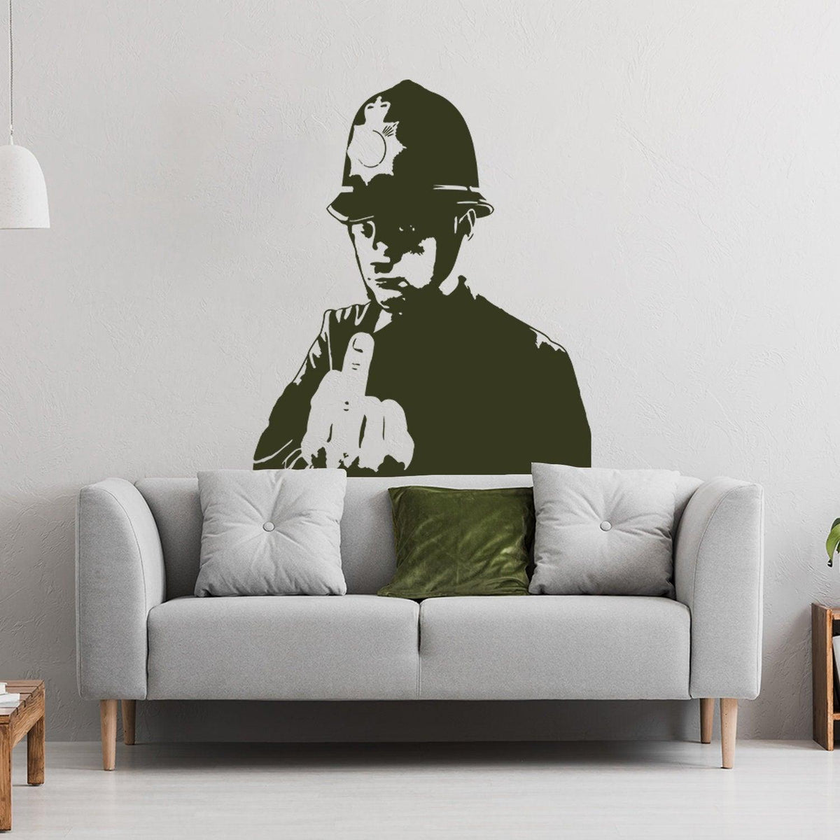Policeman middle-finger street art wall decal displayed in a modern living room.