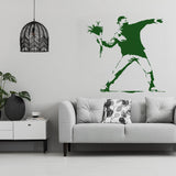 Flower thrower girl wall sticker in green on a living room wall.