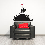 Boy and girl wall sticker with a heart-shaped balloon above a black couch.