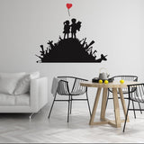 Boy and girl wall sticker with heart balloon above a dining set.
