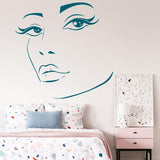 Elegant woman face wall sticker in bedroom, showcasing beauty art decor on modern wall.