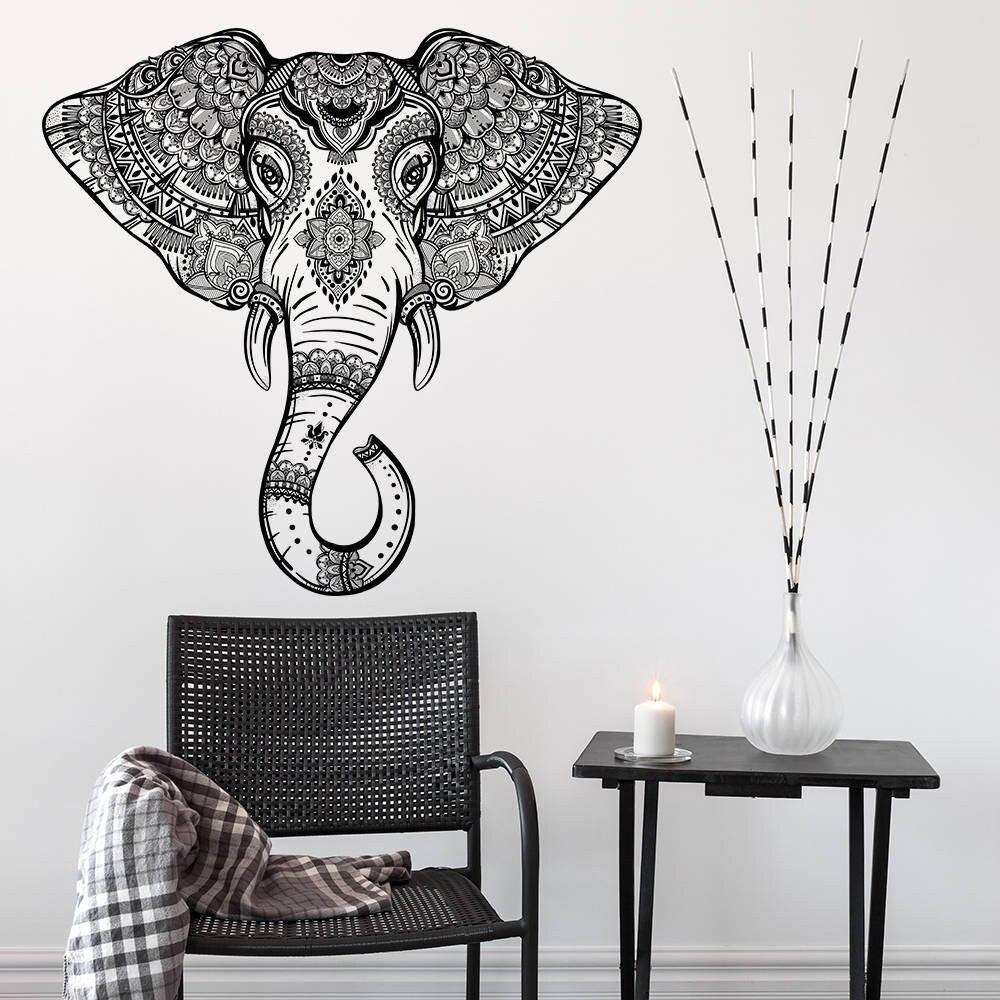 Elephant head wall vinyl sticker featuring Aztec geometric design above a chair and side table with decor.