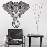Elephant head wall vinyl sticker featuring Aztec geometric design above a chair and side table with decor.