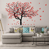 Birch tree wall decal with red leaves and birds in a stylish living room setting, enhancing interior decor.