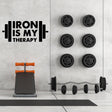 Наклейка Iron Is My Therapy на стене домашнего спортзала рядом с тренажёрами.