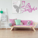 Bird with grenade street art wall sticker in a modern living room with pink decor.