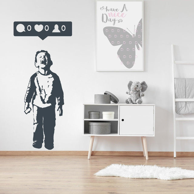 Crying boy with cellphone wall sticker featuring social media symbols.