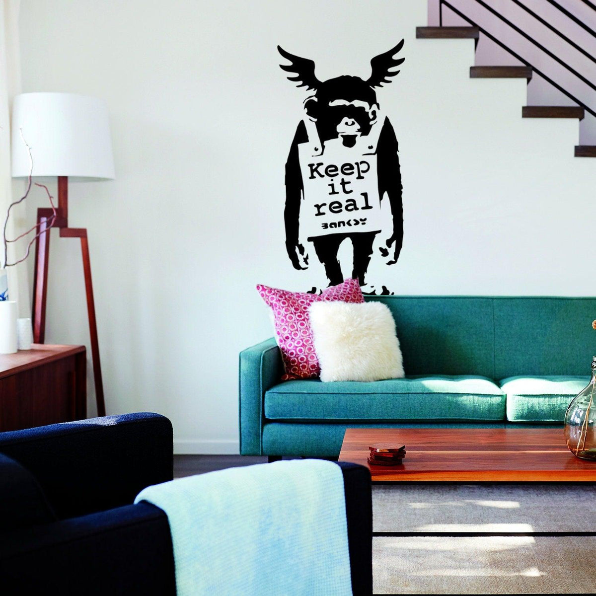 Monkey wall sticker with Keep It Real text in a modern living room.