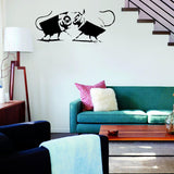 CCTV street art vinyl sticker displayed above a green sofa.