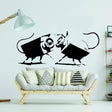 Street art CCTV wall sticker with small animal figures in a modern living room.