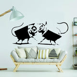 Street art CCTV wall sticker with small animal figures in a modern living room.