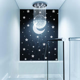 Black wall with white stars and moon decals in a modern hallway decor.