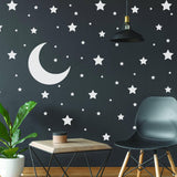 White stars and moon wall stickers on dark wall.