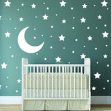 White stars and moon wall stickers in a nursery with a crib.