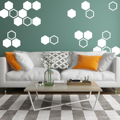 Modern honeycomb wall decals in white against a green wall.