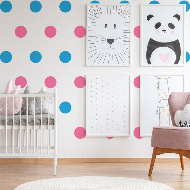 Colorful vinyl wall decals in a kids nursery with blue and pink dots, featuring cute animal art and a cozy crib.