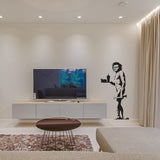 Caveman street art wall decal shown in an interior.
