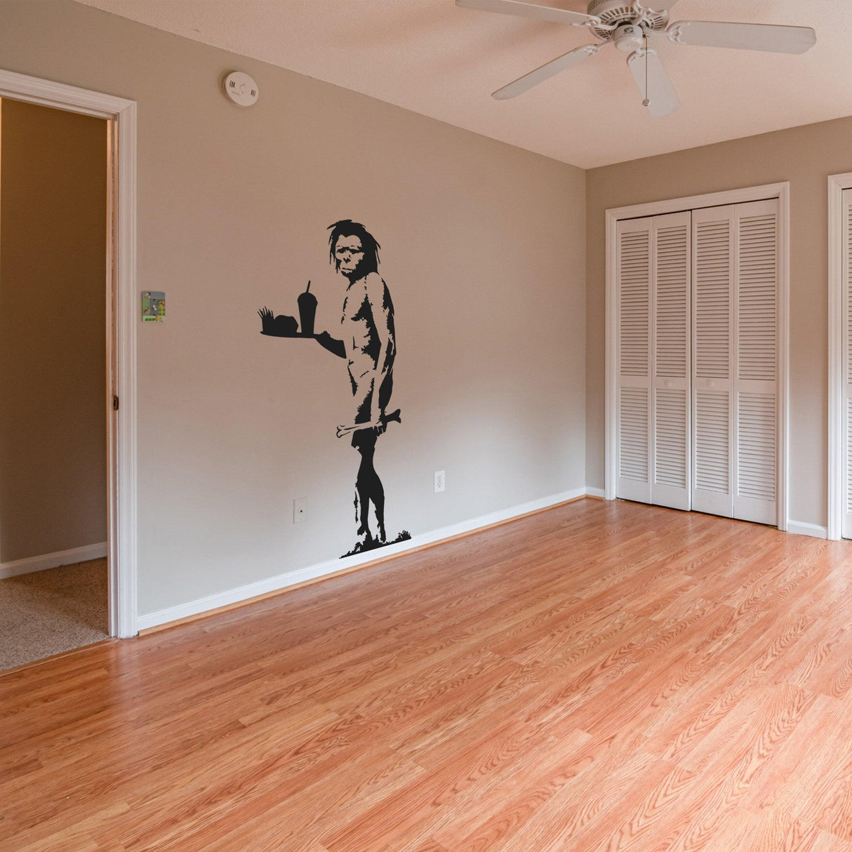 Caveman street art vinyl wall decal presentation.