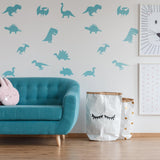 Blue dinosaur silhouette wall decals in a nursery, featuring various dinosaur shapes.