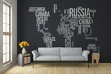 World map wall art made of words on black background, showcasing countries in creative typography decor.