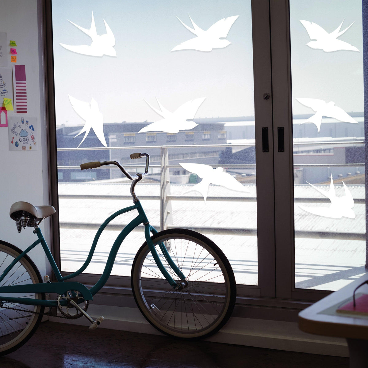 Frosted bird strike window decals on glass, showcasing decorative design and safety features to prevent bird collisions.