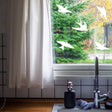 Bird strike prevention decals on a window, enhancing safety and decor in a kitchen setting.