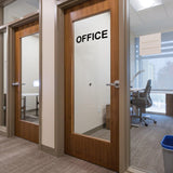 Office door with removable black vinyl lettering sticker saying 'OFFICE' on a glass panel.