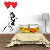 Girl with heart balloon wall sticker above a bed with colorful pillows.