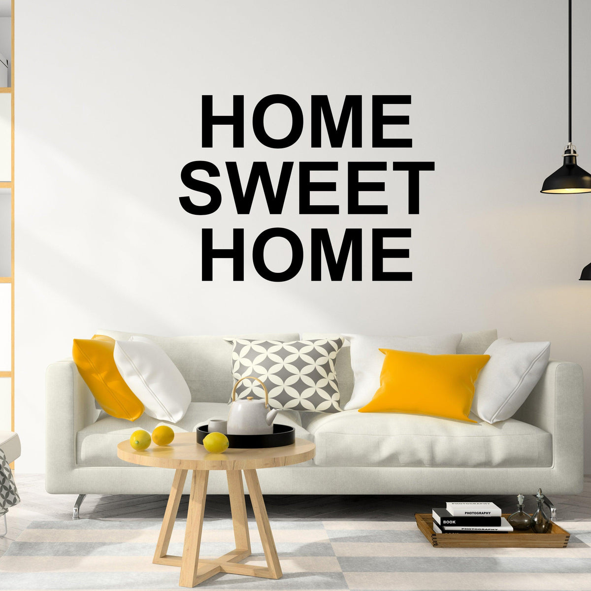Vinyl removable letter stickers displaying 'Home Sweet Home' on a living room wall above a cozy sofa.