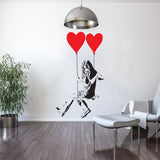 Girl on a swing with heart balloons wall sticker in a modern interior.