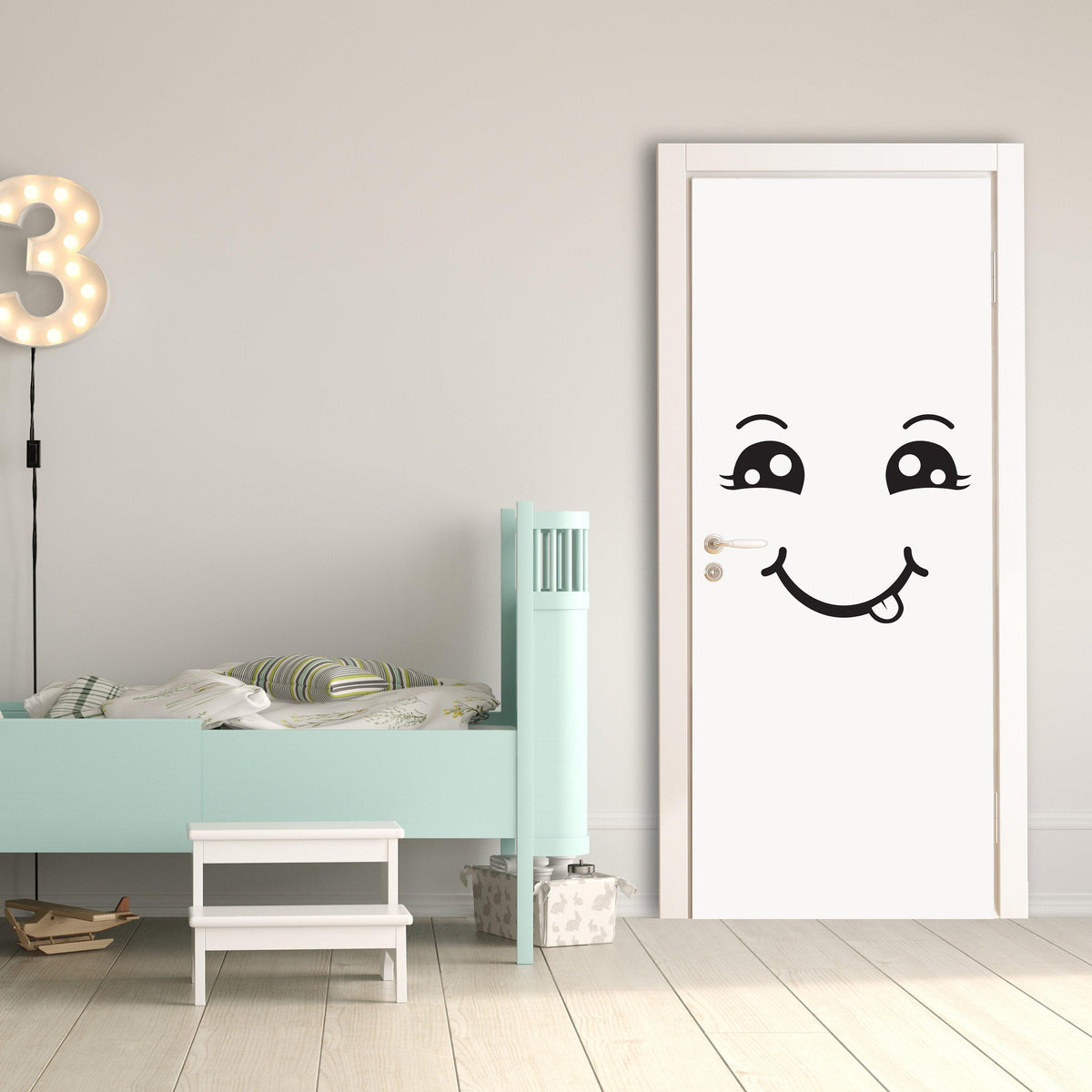 Happy face decal on a white door.