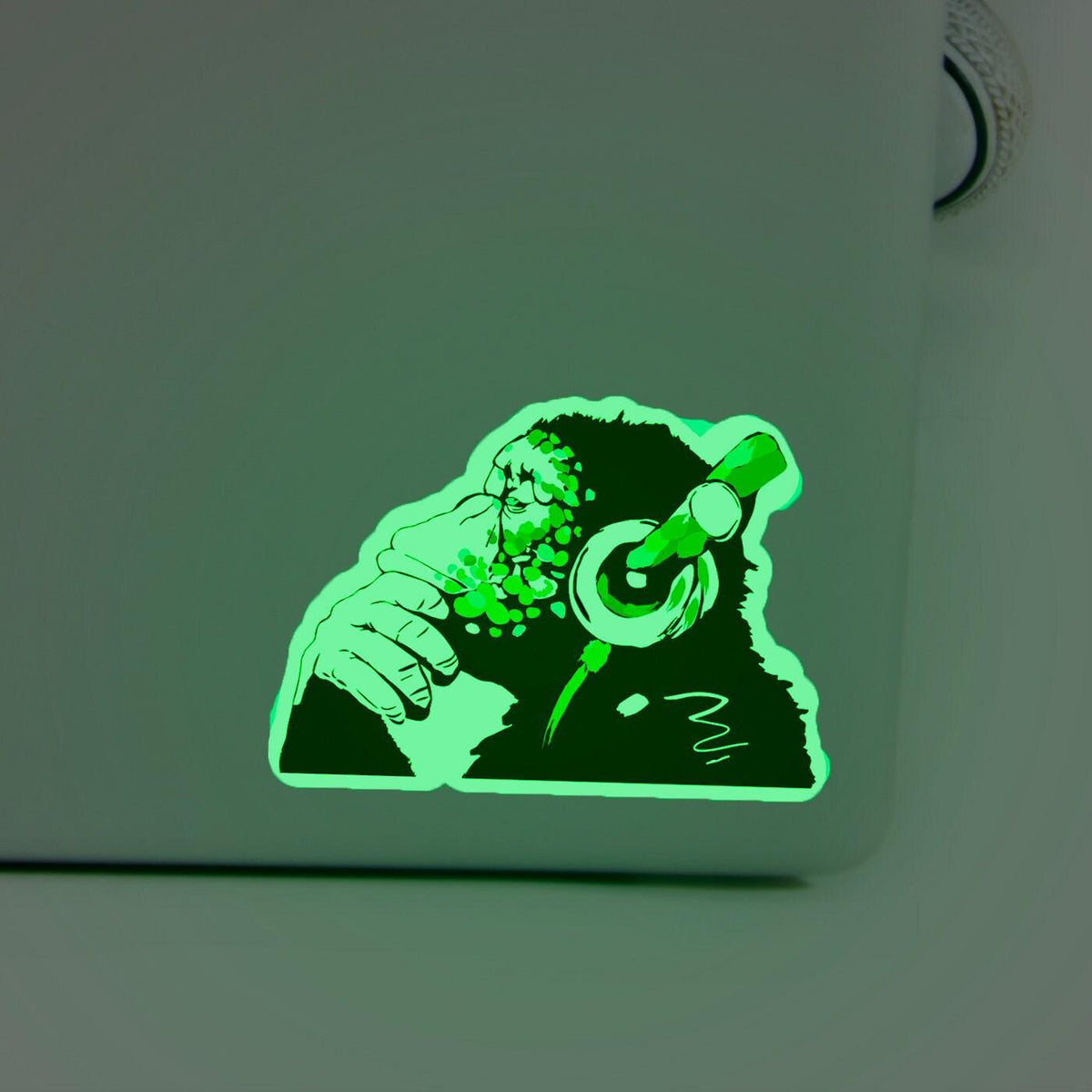 Glow in the dark monkey vinyl sticker on laptop.
