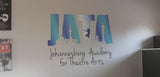 Custom theatre academy logo wall decal displayed in an interior.
