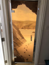 Custom door decal featuring a serene beach scene with footprints in the sand and rocky cliffs.