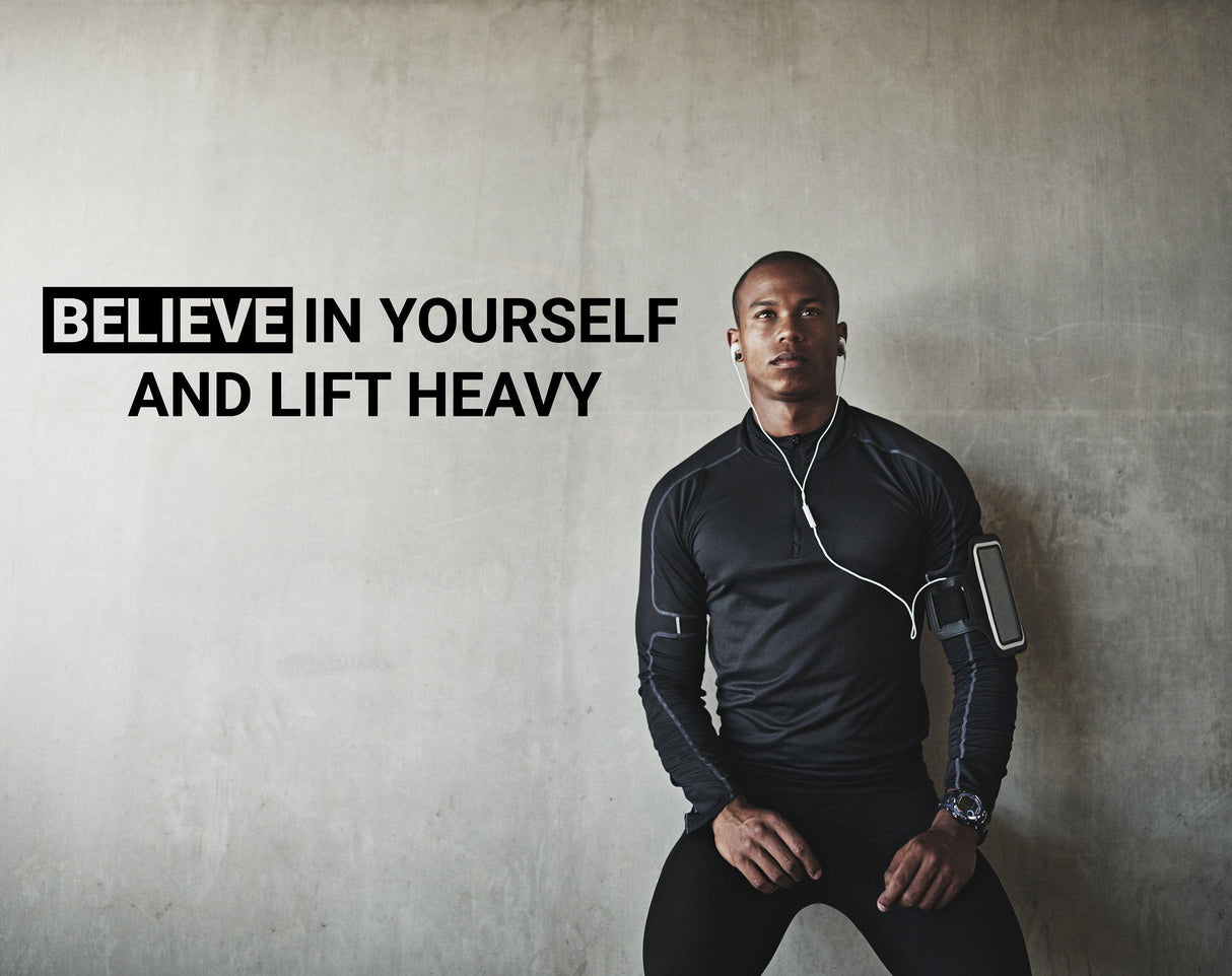 Motivational gym wall decal with text 'Believe in Yourself and Lift Heavy' in fitness space.
