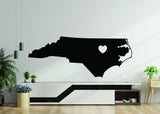 Black North Carolina state silhouette vinyl decal with heart design.