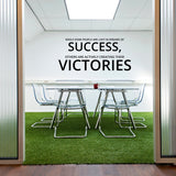 Inspirational wall art decal with motivational quote about success and victories in a modern office setting.
