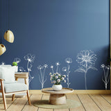 Elegant hand-sketched British wildflower wall stickers adorning a navy wall in a cozy living room.