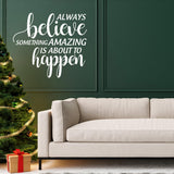 Inspiring Christmas quote vinyl sticker on wall above cozy sofa and festive tree.