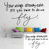 Stylish vinyl decal of the quote 'Your wings already exist. All you have to do is fly.' in a modern living room.